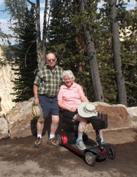 FJ and Carole (on her scooter) visiting a viewpoint at Yellowstone National Park
