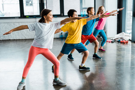 Four boys and girls doing lunging exercises.