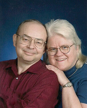 2004 headshot of FJ and Carole, smiling and leaning toward each other.